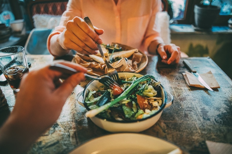 A Man and Woman Share a Bowl of Cooked Vegetables, Representing a Diet to Improve Fertility in Males.