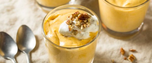 Three Glass Cups of Pumpkin Pudding Topped with Greek Yogurt and Maple Granola
