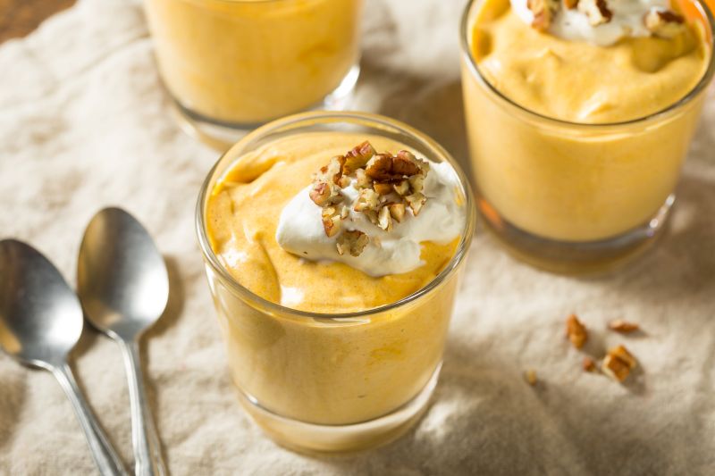 Three Glass Cups of Pumpkin Pudding Topped with Greek Yogurt and Maple Granola