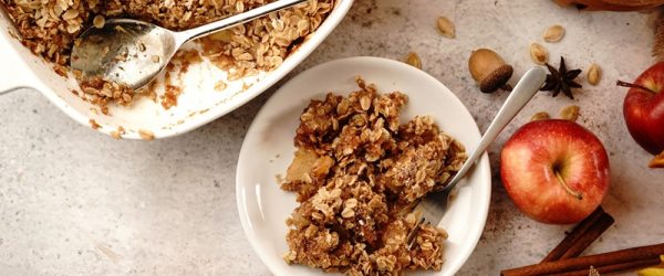 A Vegan Apple Crisp Recipe is in a Casserole Dish.