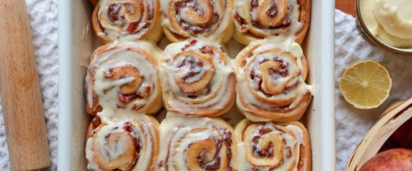 Apple-Filled Cinnamon Rolls_Resized_Anastasia Midas.jpeg Glazed Apple Cinnamon Rolls in Square Baking Dish on Table Strewn with Apples and Lemons