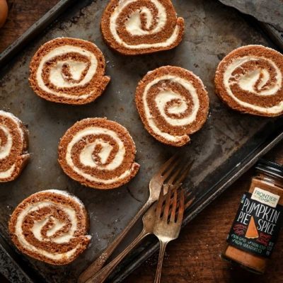 Classic Pumpkin Roll Slices with Cream Cheese Filling on Baking Sheet with Frontier Co-Op Pumpkin Pie Spice and Vintage Forks