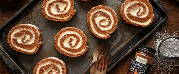 Classic Pumpkin Roll Slices with Cream Cheese Filling on Baking Sheet with Frontier Co-Op Pumpkin Pie Spice and Vintage Forks