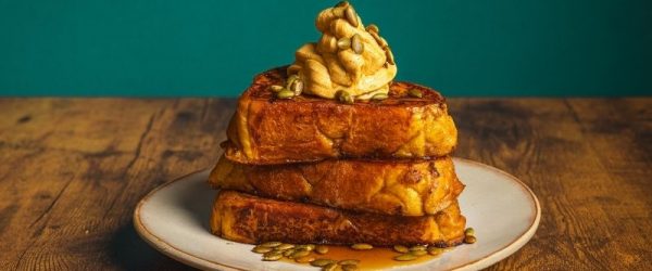 Pumpkin Spice French Toast With Whipped Pumpkin Butter Pumpkin Spice French Toast With Whipped Pumpkin Butter Stacked on a Plate With Maple Syrup and Pumpkin Seeds