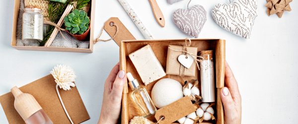 Preparing self care package, seasonal gift box with plastic free zero waste cosmetics products. Personalized eco friendly basket for family and friends for thankgiving, christmas, mothers day