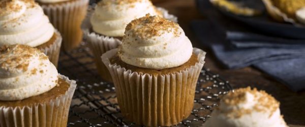 Gluten-Free Pumpkin Muffins with Cream Cheese Frosting_Resize_Maureen Knowles Pumpkin Muffins With Cream Cheese Frosting on Cooling Rack with a Pumpkin on the Table in the Background