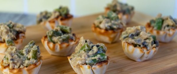 Green Bean Casserole Bites Sit on a Wooden Cutting Board.