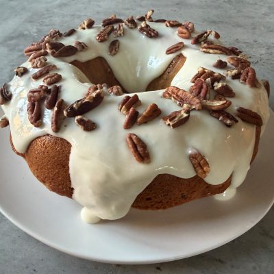 Maple Pecan Bundt Cake With Frosting On Counter