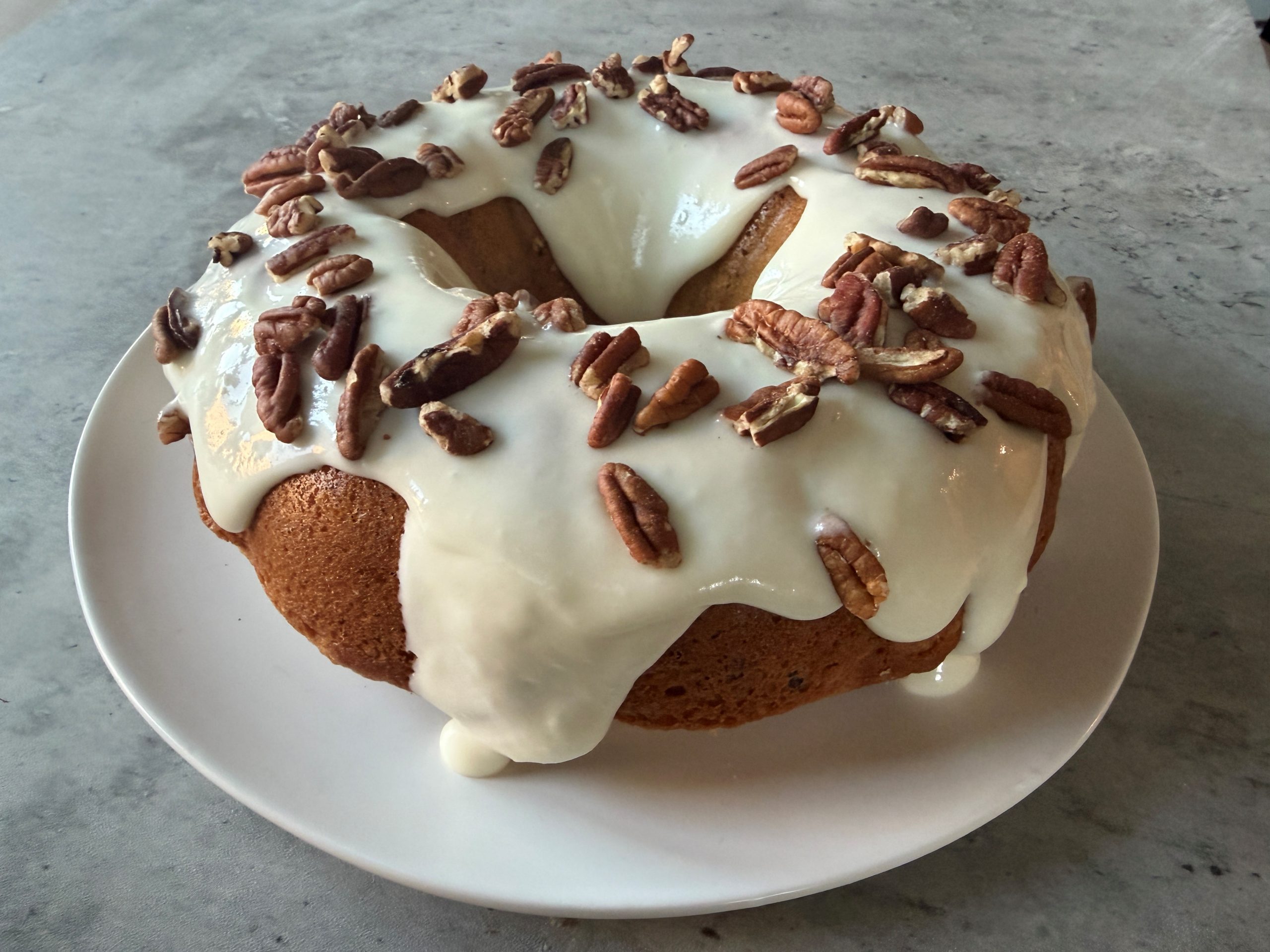Maple Pecan Bundt Cake With Frosting On Counter