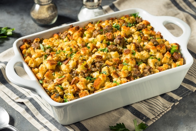 A Casserole of Low FODMAP Stuffing is Garnished With Fresh Herbs.