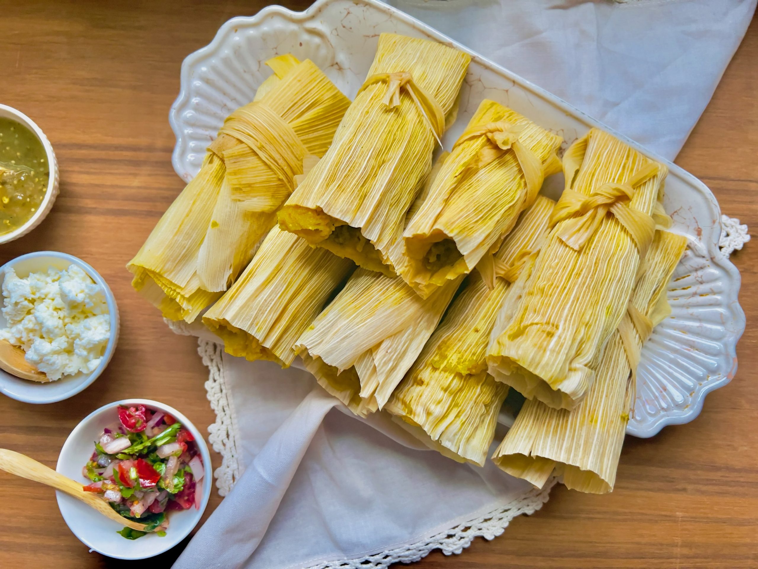 Savory Pumpkin Tamales With Dips on Wood Table