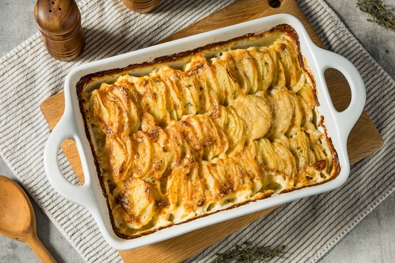 A White Casserole Dish Shows a Scalloped Potatoes Recipe.