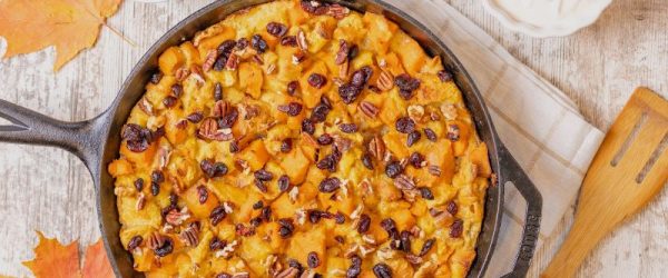 Sweet Potato Bread Pudding in Cast Iron Skillet, Topped with Cranberries and Pecans