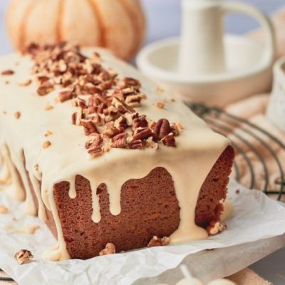A Sweet Potato Pound Cake With a Drizzle of Maple-Vanilla Glaze and a Healthy Sprinkling of Chopped Pecans on a Festive Fall Tabletop