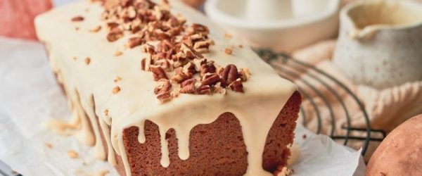 A Sweet Potato Pound Cake With a Drizzle of Maple-Vanilla Glaze and a Healthy Sprinkling of Chopped Pecans on a Festive Fall Tabletop
