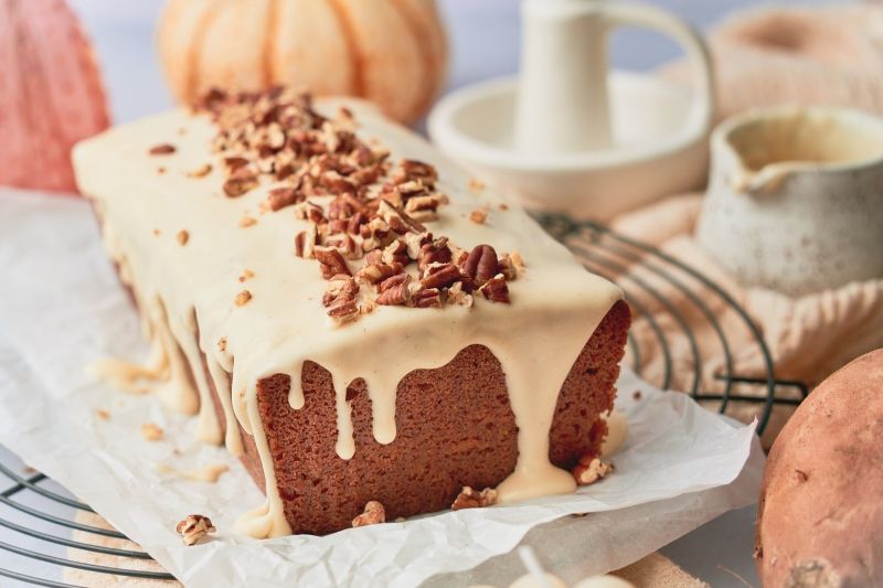 A Sweet Potato Pound Cake With a Drizzle of Maple-Vanilla Glaze and a Healthy Sprinkling of Chopped Pecans on a Festive Fall Tabletop