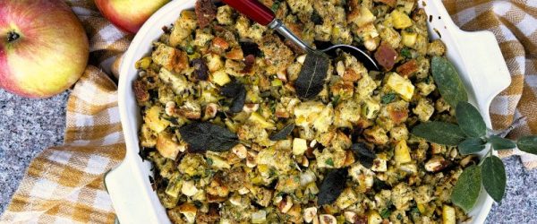 Sage Brown Butter & Apple Stuffing in Oven Pan on Granite Counter with Linen Kitchen Towel and Whole Apples