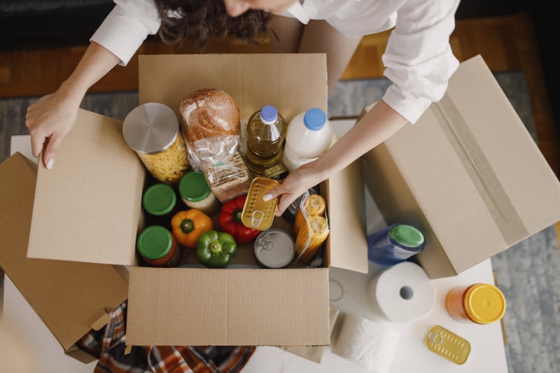 Overhead View of Open Box With the Best Non Perishable Foods to Donate to a Food Pantry