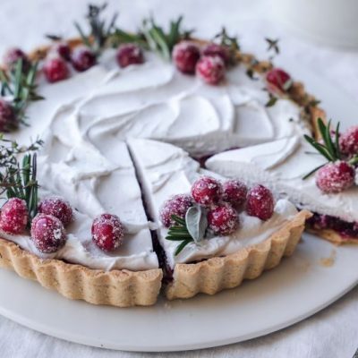 Coconut Cream Pecan-Raspberry Tart Sliced, Revealing Layers of Crust, Pecan, Raspberry Jam and a Pillow of Coconut Cream