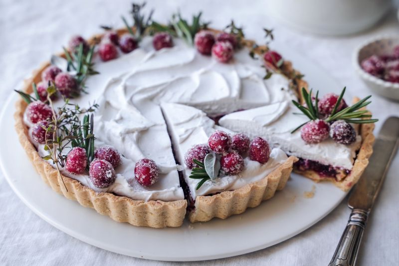 Coconut Cream Pecan-Raspberry Tart Sliced, Revealing Layers of Crust, Pecan, Raspberry Jam and a Pillow of Coconut Cream