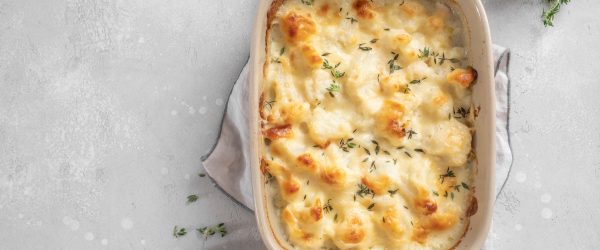 Cauliflower Gratin With Vegan Cheese on Counter in Baking Dish