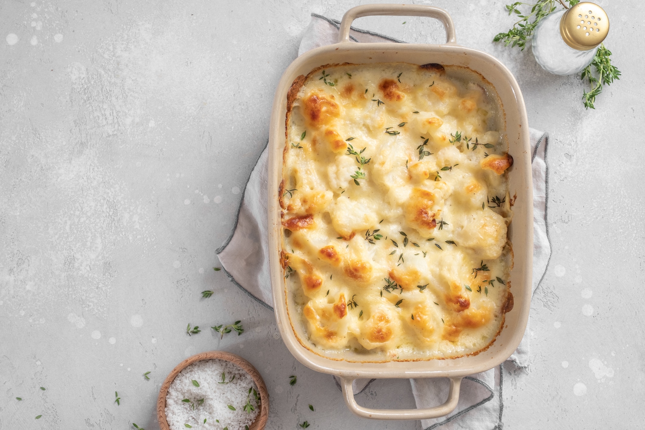 Cauliflower Gratin With Vegan Cheese on Counter in Baking Dish