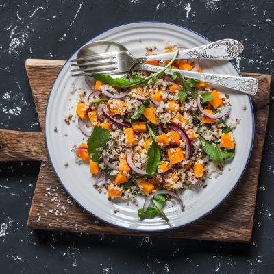 Nourishing Winter Salad With Roasted Vegetables on Dark Background