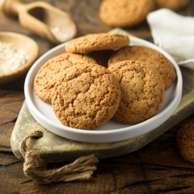 Gingersnaps Piled on a Round Plate on a Rustic, Rough-Hewn Wood Table