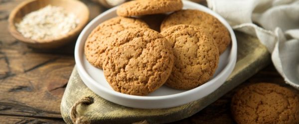 Gingersnaps Piled on a Round Plate on a Rustic, Rough-Hewn Wood Table