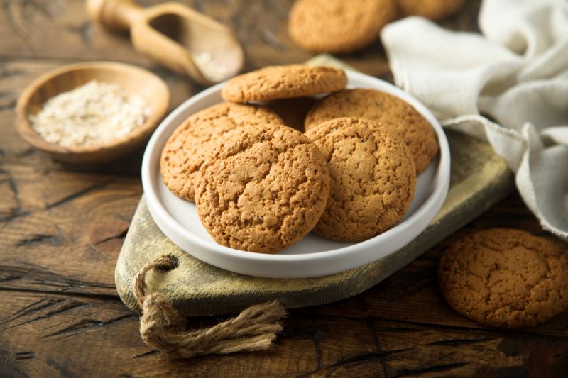 Gingersnaps Piled on a Round Plate on a Rustic, Rough-Hewn Wood Table