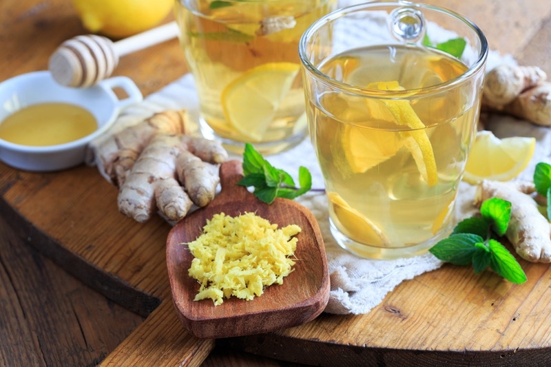 Ginger Tea Benefits: 7 Reasons to Sip Daily A Glass Mug Holds Ginger Tea With Lemon Slices, Representing Ginger Tea Benefits.