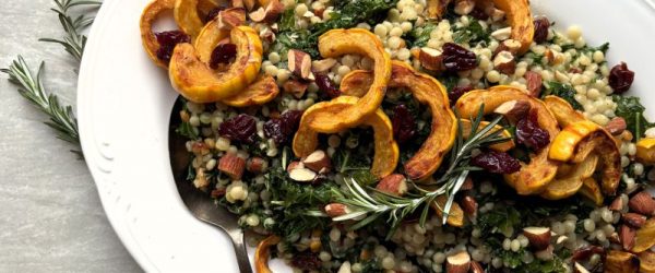 Toasted Spiced Pearl Couscous & Delicata Squash_Resized_Cathy Vogt Toasted Couscous with Almonds, Wilted Greens, Tart Dried Cherries and Roasted Delicata Squash Piled on an Oval Serving Platter for a Holiday Feast