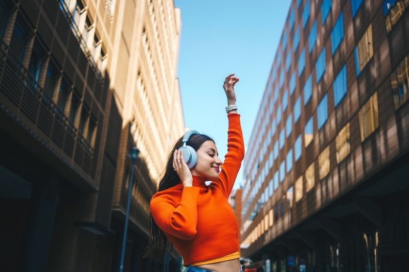 Woman Dopamine Dressing Wearing Bright Color Sweater With City Background