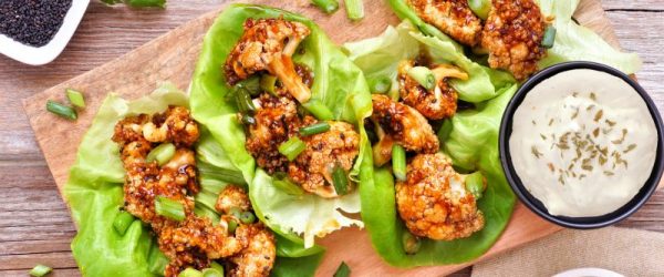 Golden Honey-Garlic Cauliflower Lettuce Wraps on Wooden Serving Board