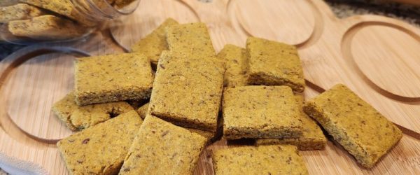 Gone Fishin' Treats_Resized Image_Carrie Miller A Scattering of Homemade Pet Treats Made with Fish on a Wooden Paw-Shaped Board