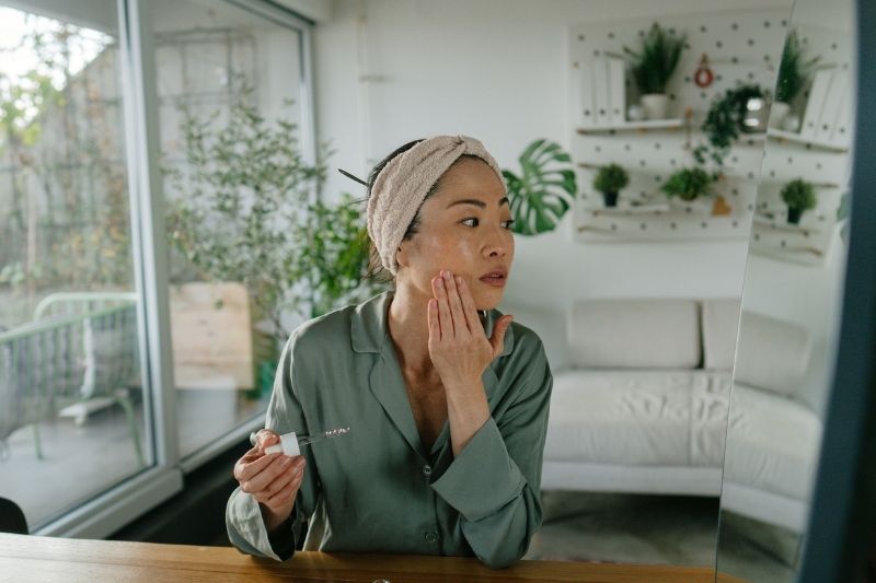 Woman Practicing Looking in Mirror Mindful Skincare