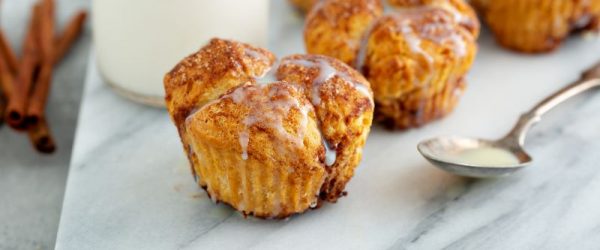 Monkey Bread Muffins Drizzled with Sugary Glaze on Marble Serving Board