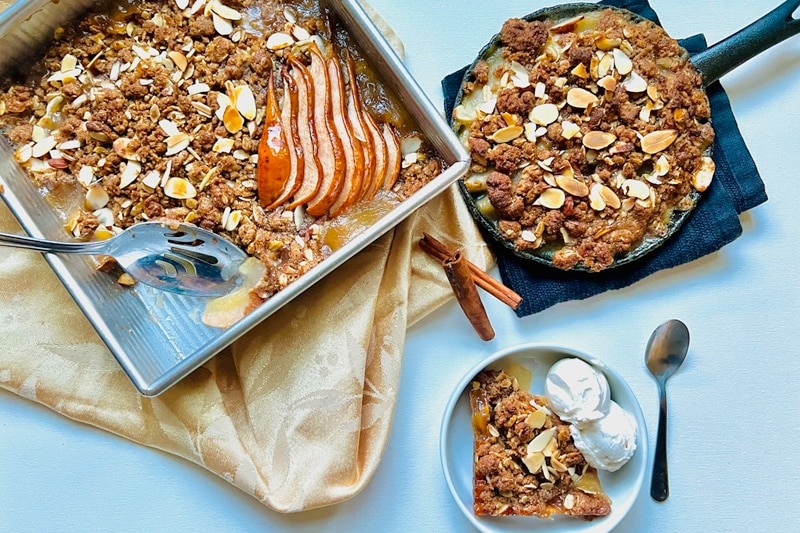 A Pear Crisp Recipe is Topped With Sliced Almonds and Crumble Topping.