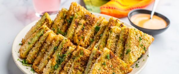 Shrimp Toast Recipe Shown on Serving Plate with a Bowl of Sauce Nearby