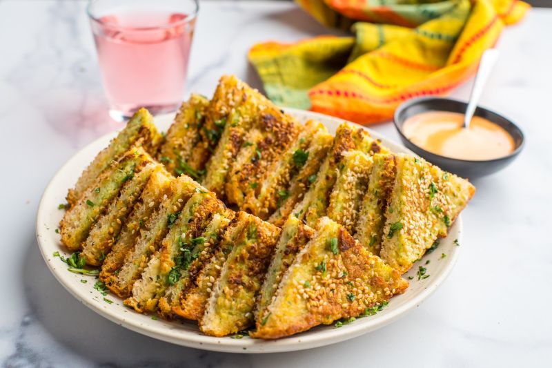 Shrimp Toast Recipe Shown on Serving Plate with a Bowl of Sauce Nearby