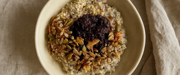 Superfoods High-Protein Oatmeal in a Bowl Topped with Seeds, Nuts and Cranberries