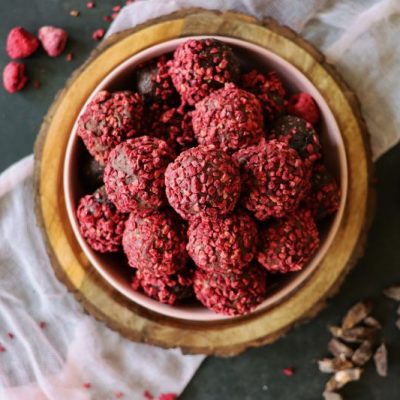 Vegan Raspberry-Covered Chocolate Truffles on a Wooden Bowl