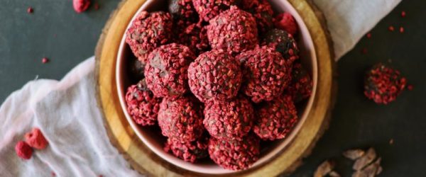 Vegan Raspberry-Covered Chocolate Truffles on a Wooden Bowl