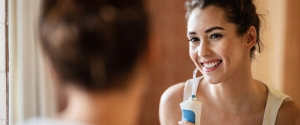 Woman Using Water Flosser