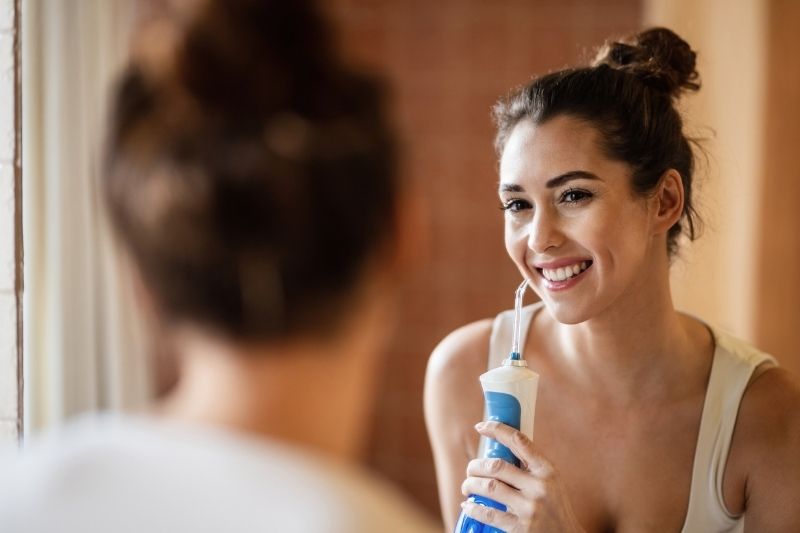 Woman Using Water Flosser