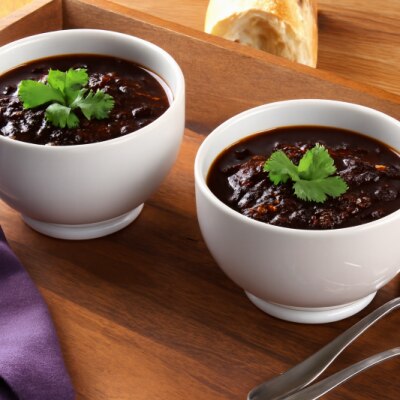 Chocolate-Infused Black Bean Chili Recipe in Two Bowls Topped with Cilantro