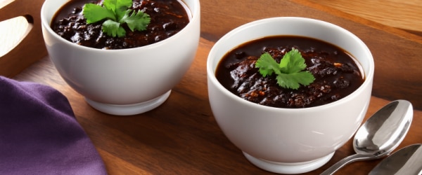 Chocolate-Infused Black Bean Chili Recipe in Two Bowls Topped with Cilantro