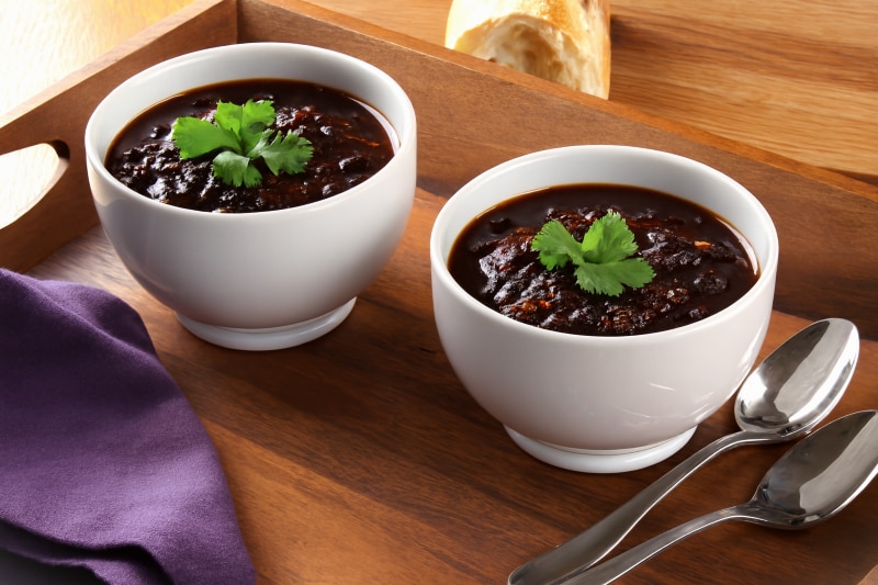 Chocolate-Infused Black Bean Chili Recipe in Two Bowls Topped with Cilantro