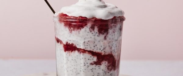 A Small Glass Jar is Filled With Layers of Strawberry Chia Pudding.