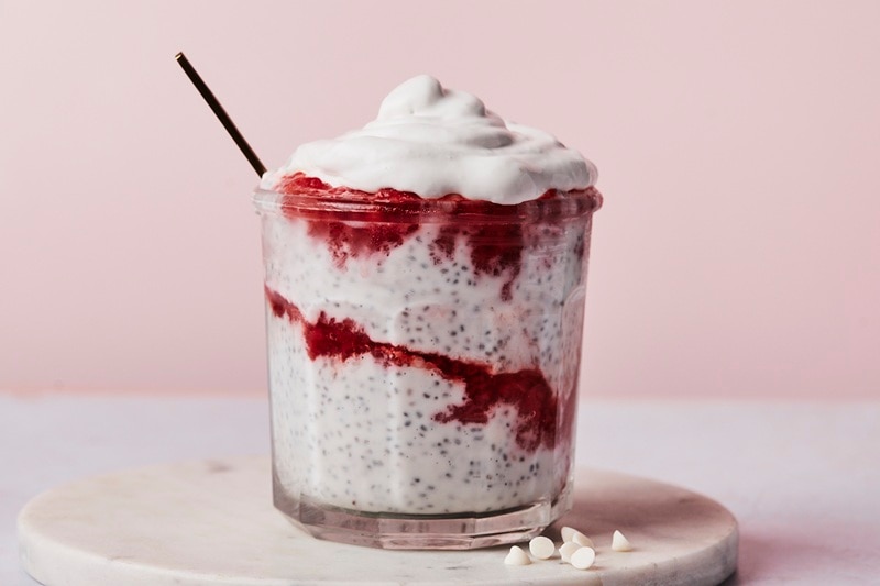 A Small Glass Jar is Filled With Layers of Strawberry Chia Pudding.